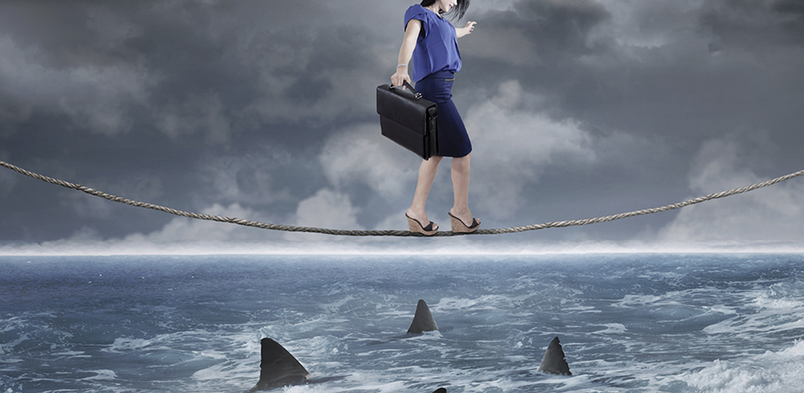 woman walking tightrope over shark