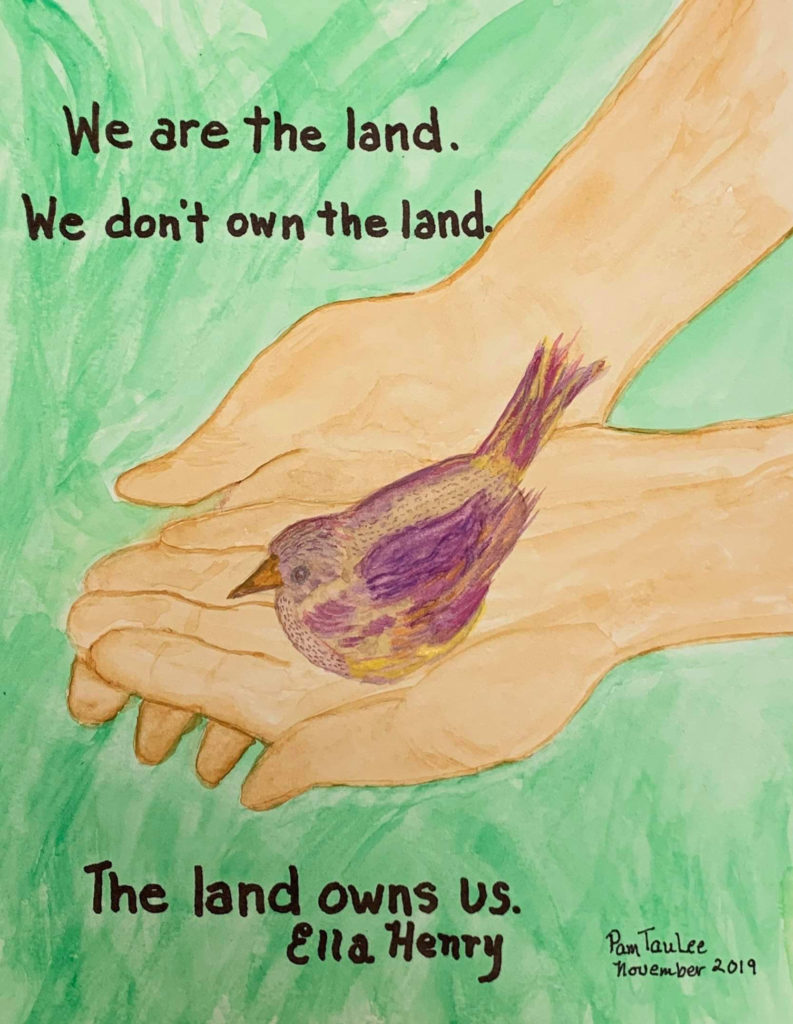 The text on the artwork says: We are the land. We don't own the land. The land owns us.